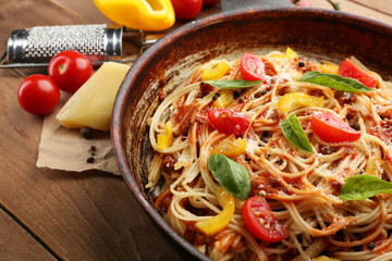 Homemade Spaghetti Bolognese on pan, on wooden background