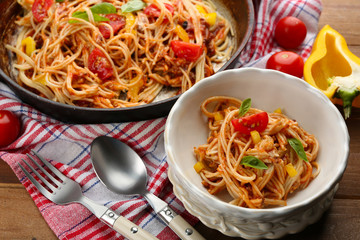 Homemade Spaghetti Bolognese with parmesan cheese in white bowl, on color wooden background