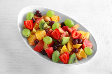 Fresh fruit salad on white wooden table