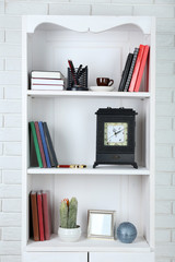 Books and decor on shelves in cupboard