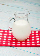 jug of milk on a red checkered tablecloth