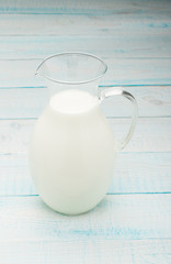 a jug of milk on wooden table