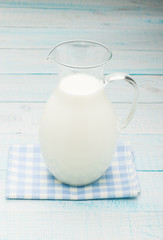 jug of milk on a blue checkered tablecloth