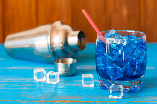 Cool refreshing blue curacao cocktail in pounchy glass with