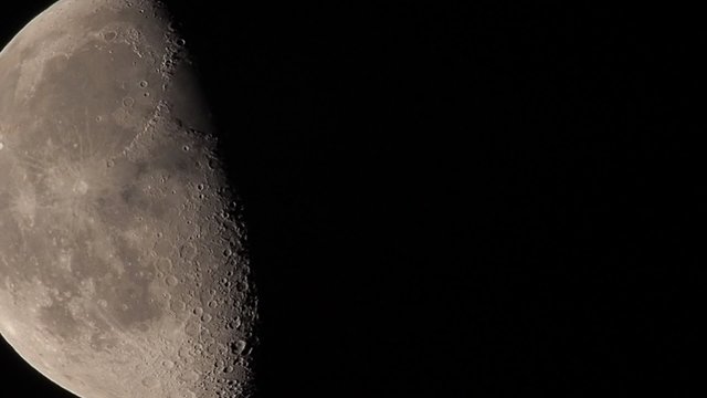 Moon in waning gibbous showing crater details and atmospheric jitter called "seeing"  in astronomy