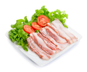 Sliced Bacon with vegetable in the dish on background