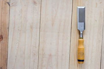 carpenter chisel on wood background