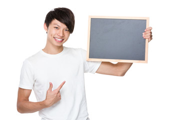 Asian young man showing with chalkboard