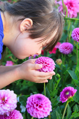 Little girl enjoy with the flowers