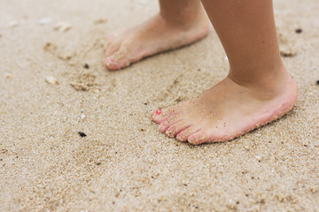 Barefoot child in the shallow sea