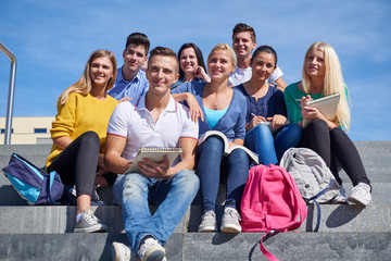 students outside sitting on steps