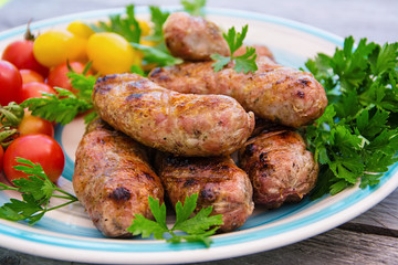 Homemade sausages  with vegetables on the grill