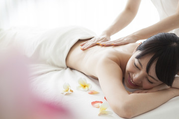 Obraz na płótnie Canvas Young women receiving a massage at the spa