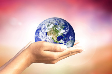 We love the world of ideas.world in human hands. Natural background blur. Elements of this image furnished by NASA.