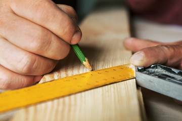 Fototapeta na wymiar Male hands with ruler and pencil closeup.