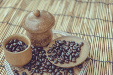 Coffee beans and coffee cup set on bamboo wooden background.Phot
