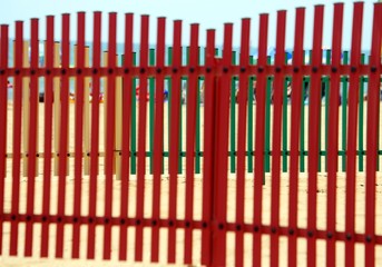colorful fence of a playground on the beach in summer