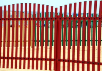 Fototapeta premium colorful fence of a playground on the beach in summer