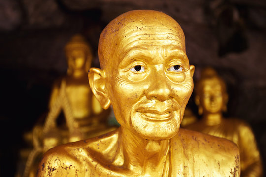 Closeup image of group of golden buddhism statues in Thailand.