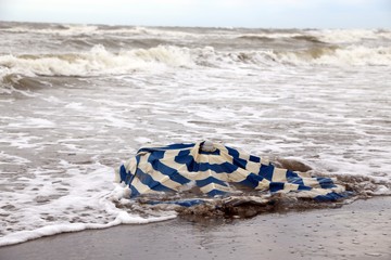 beach umbrella in the sea after the terrible storm