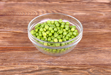 peas on a wooden bowl in a glass