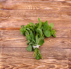 Bunch of mint on the boards, wooden background
