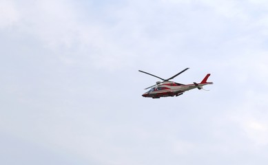 Fototapeta na wymiar big helicopter of fireman flies in the sky during an emergency