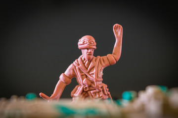 Closeup of action mini toy soldier on black background