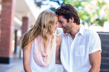 Smiling couple sitting with joined head