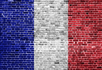 Flag of France painted on brick wall, background texture