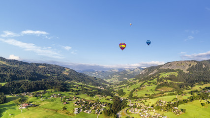 Panoramic view of mountains with three balloons