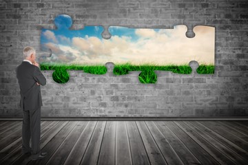 Composite image of thoughtful businessman standing