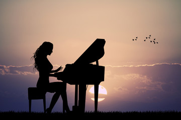 woman plays the piano at sunset - obrazy, fototapety, plakaty