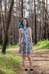 Naklejka na ściany i meble lonely blue-haired pretty girl walk in dreamy forest