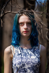 Fototapeta premium lonely blue-haired pretty girl walk in dreamy forest