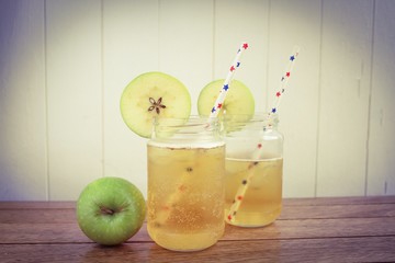 Cider apple juice in glass jars on a wooden surface