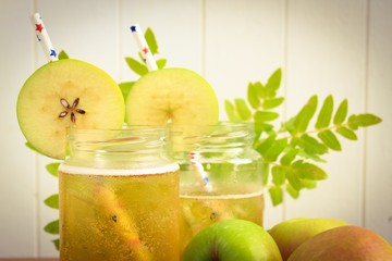 Cider apple juice in glass jars with apples