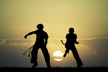 Capoeira silhouette at sunset