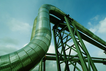 Industrial zone, Steel pipelines and valves against blue sky