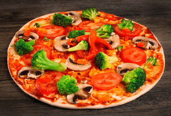 Vegetarian pizza on a wooden table.