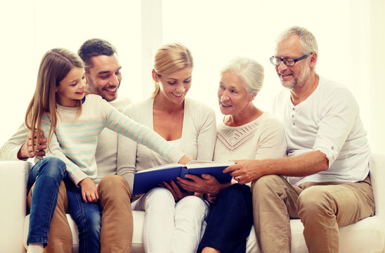 happy family with book or photo album at home