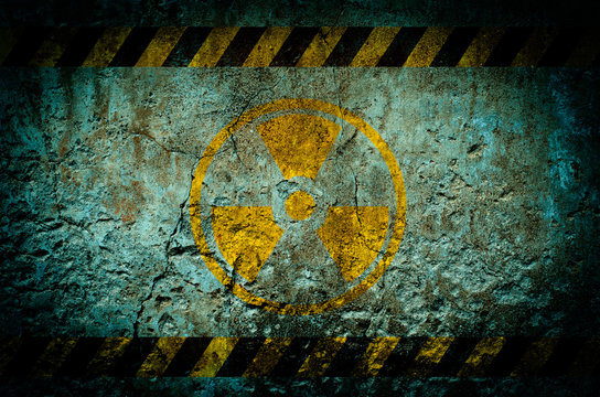 Nuclear radiation warning symbol on grunge wall background