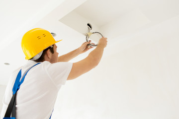 close up of builder or electrician running wires
