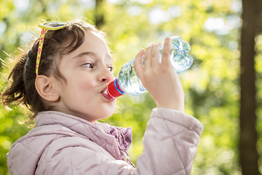 Photo of little girl drinking water