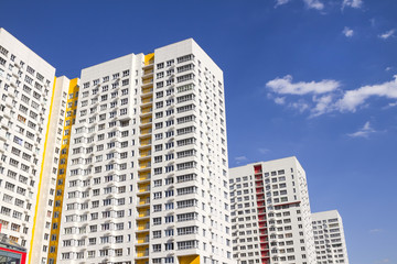 Multistory new modern apartment building against the blue sky. Stylish living block of flats. Newly...