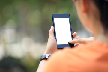 closeup of young woman hands use smart phone in city