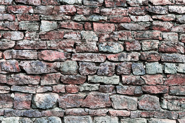Stone wall macro closeup, horizontal stonewall pattern background, old aged weathered red grey...