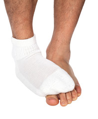 Man's foot with sock covers the other foot