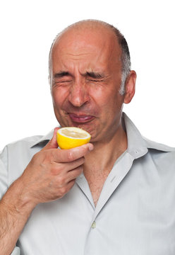 Man puckers after tasting a lemon