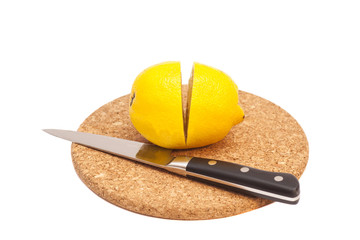 Sliced lemon and knife on wooden cutting board isolated